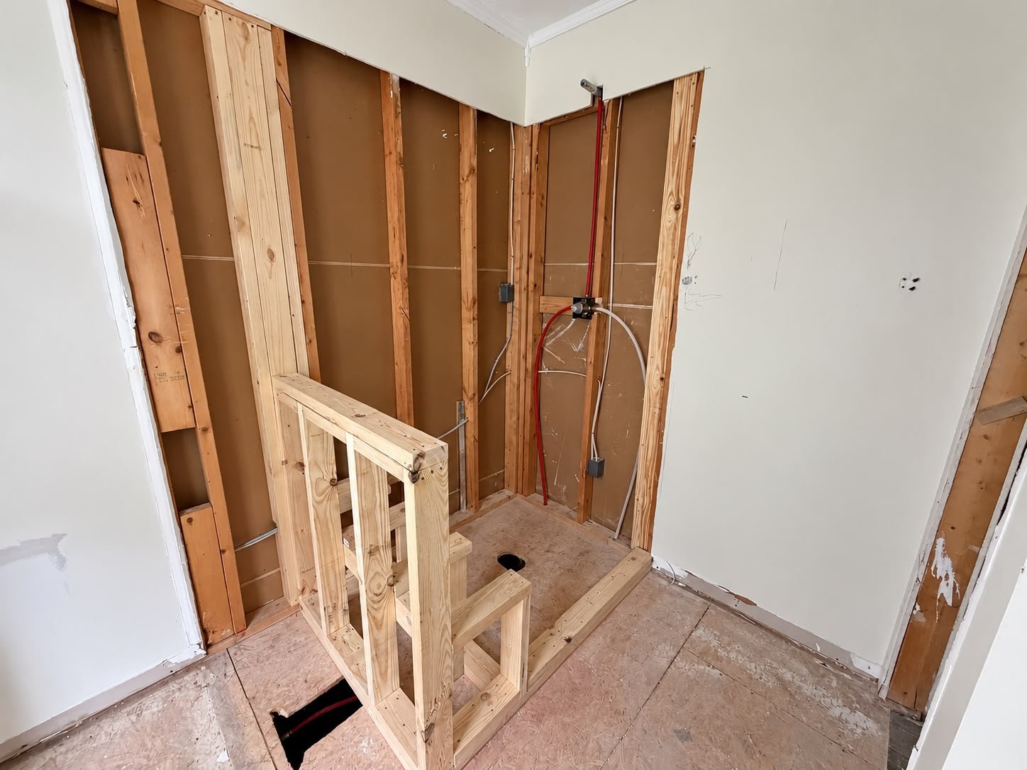Custom shower framing with a built-in bench designed to meet the homeowner's mobility needs