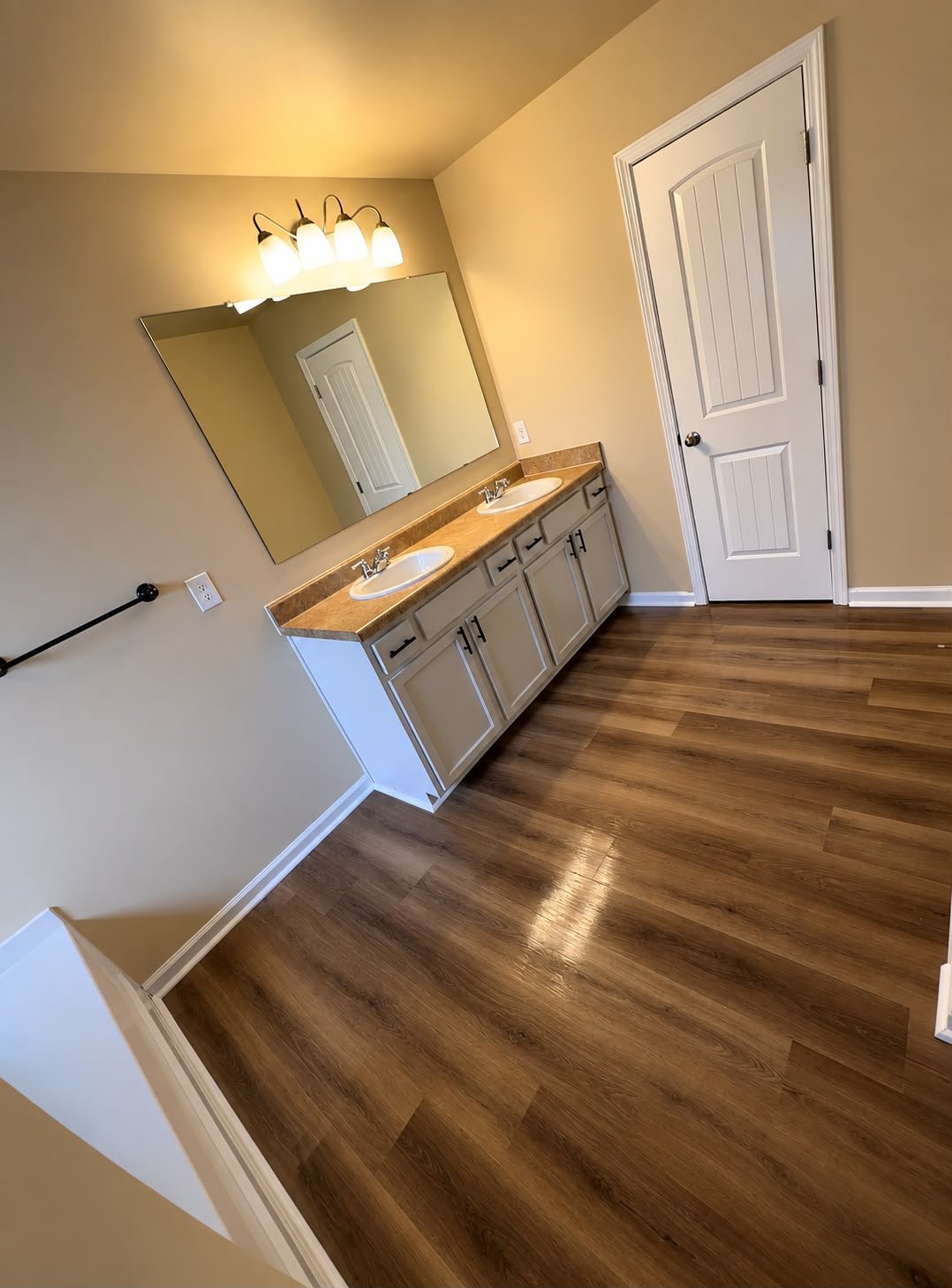 Completed double-vanity bathroom with refreshed cabinetry and new flooring