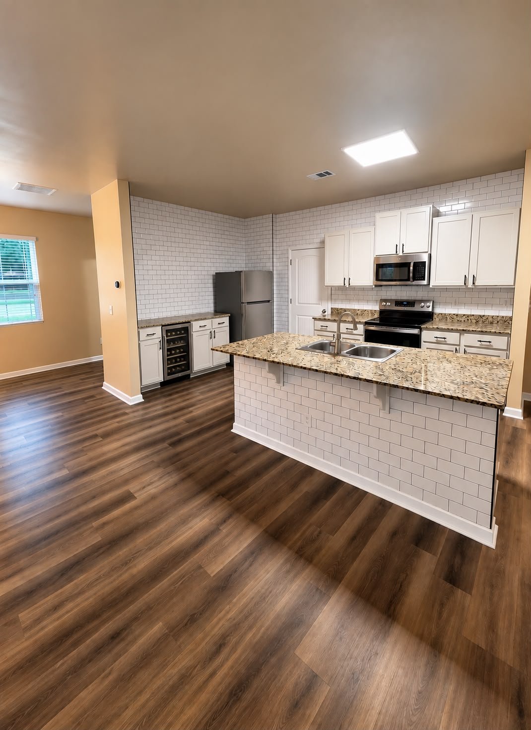 Completed kitchen with fresh paint, backsplash and decorative island finish